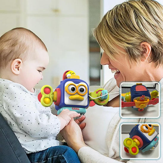 La photo montre une maman qui regarde son bébé captivé par le jouet cube de chez Montessori.