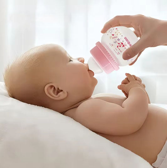 Baby bottles, specifically wide-bore PP bottles with bear-shaped caps, available in pink